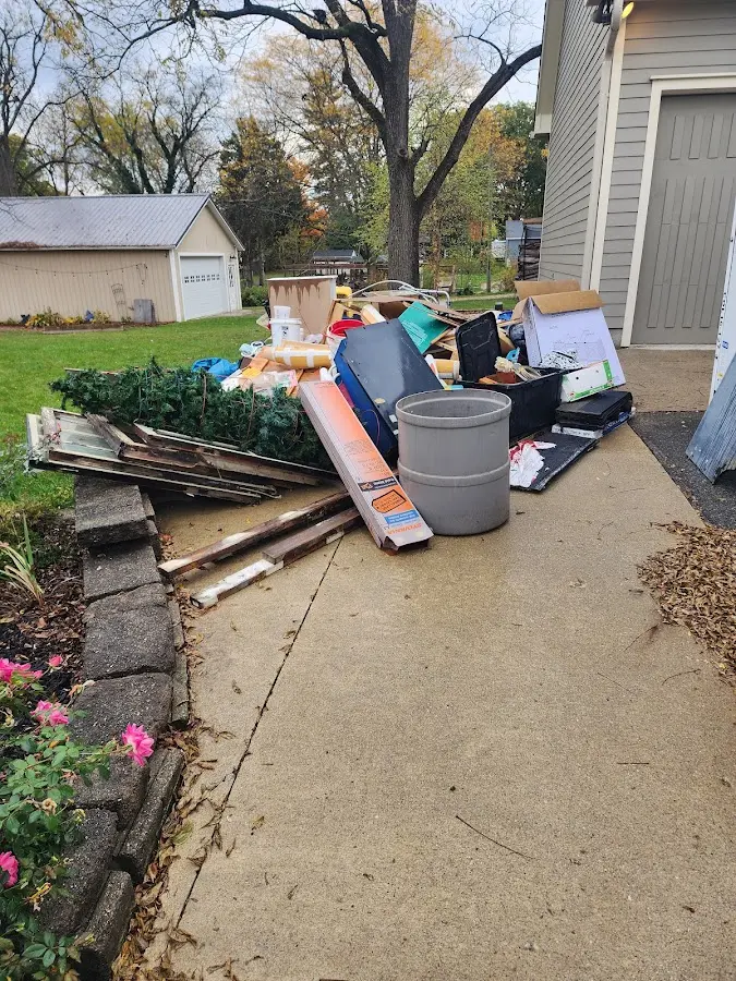 Dumpster being loaded with debris for 10 Yard Dumpster Rental in Newfane